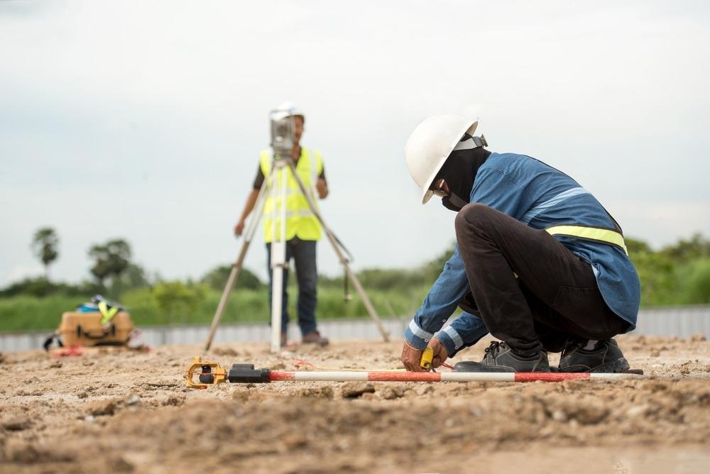 African land surveyors using professional surveying equipment
